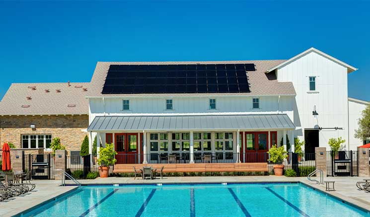 Home with a SunPower Maxeon solar power installation facing a beautiful pool in Southern California